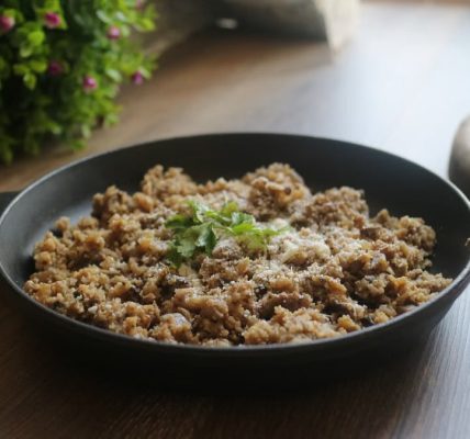 Tasty minced meat dish garnished with herbs in a black skillet, perfect for a delicious homemade meal.